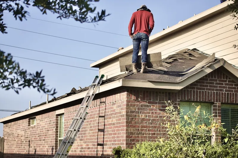 Professional roofer working on a residential roof in Oakhaven